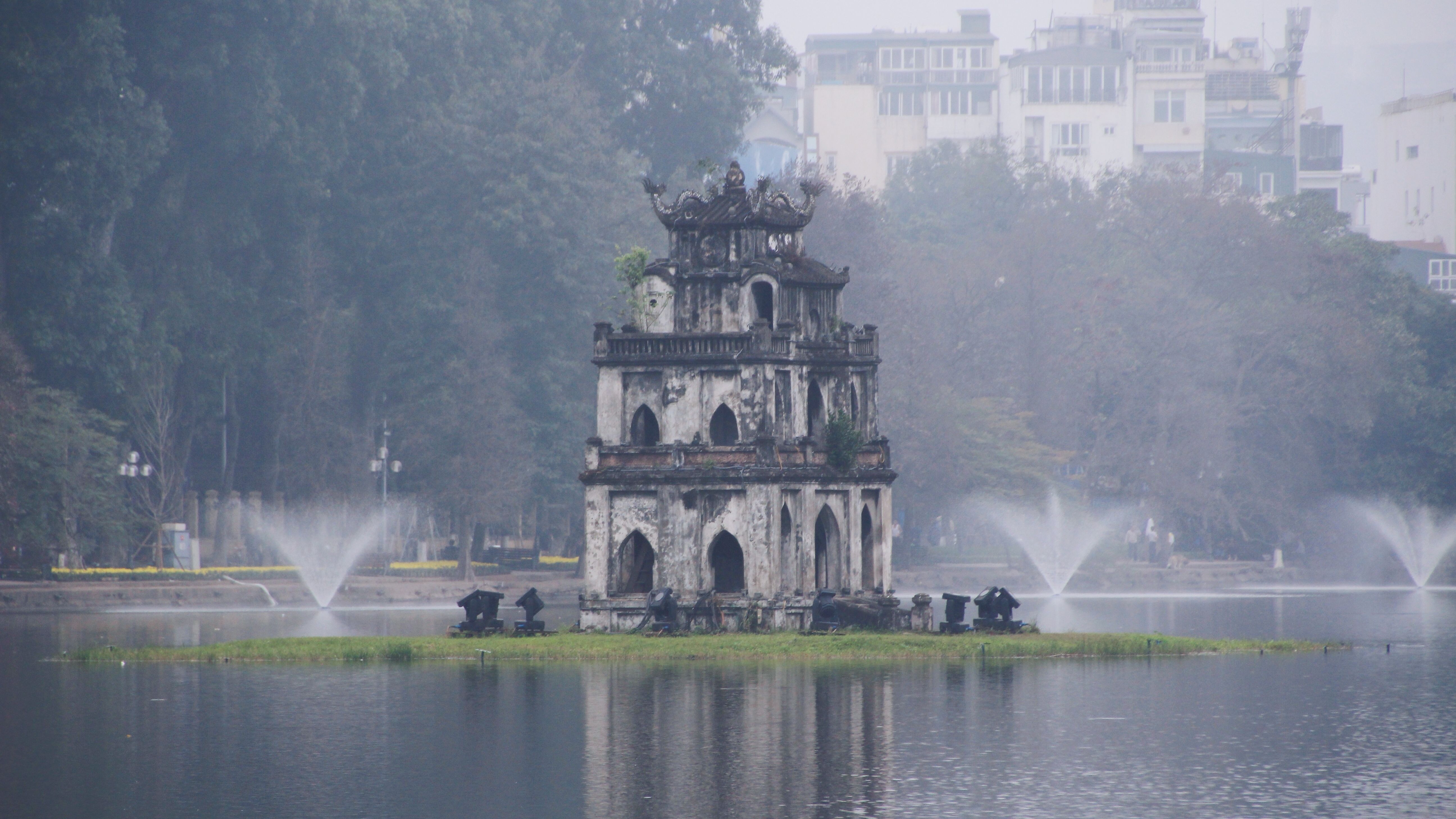 The Turtle Tower (Tháp Rùa) standing on a small island near the center of the lake is linked to the legend