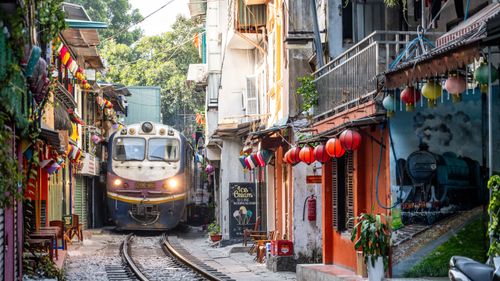 Train is comming through Hanoi train street